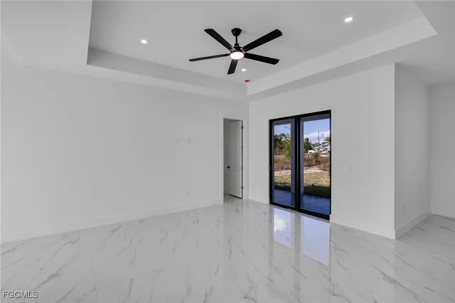 wooden floor in an empty room with a ceiling fan