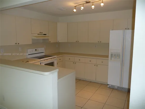 a view of a storage and utility room with cabinets