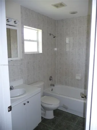 a bathroom with a toilet sink and bathtub