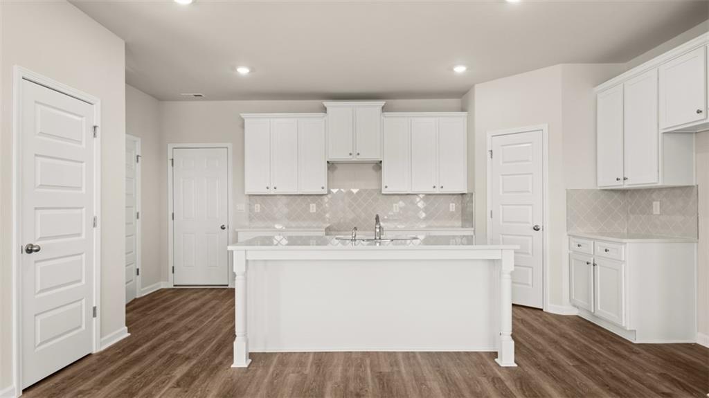 906 Stow Lane Monroe, GA 30655 - Photo 9 of 28 a kitchen with stainless steel appliances granite countertop a sink and cabinets