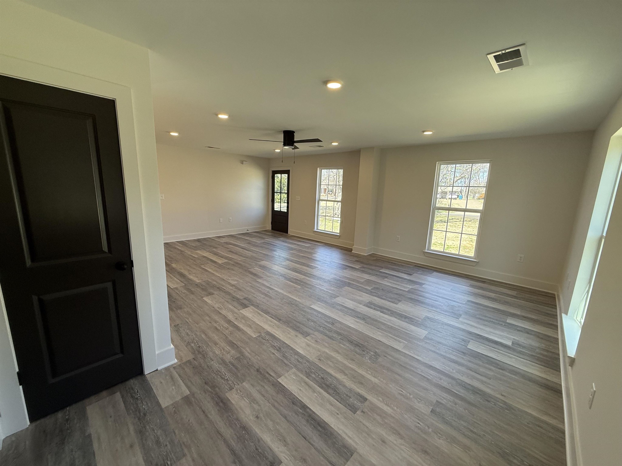 963 Highway 54 Covington, TN 38019 - Photo 12 of 26 an empty room with wooden floor and windows