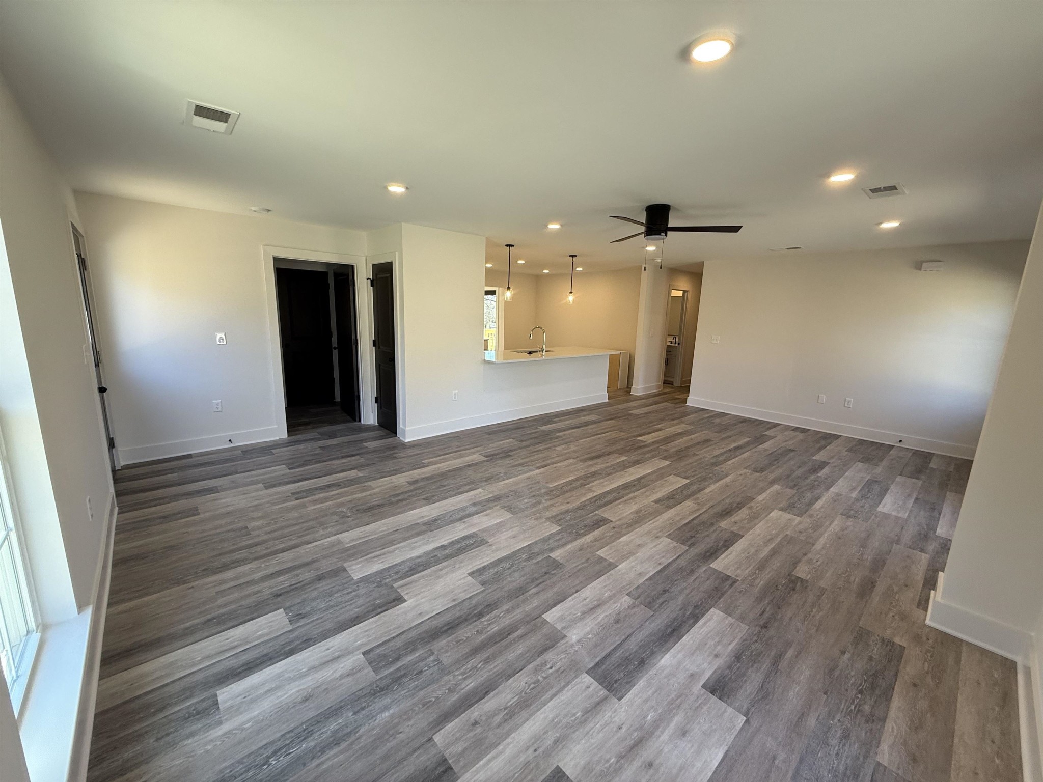 963 Highway 54 Covington, TN 38019 - Photo 14 of 26 an empty room with wooden floor and windows