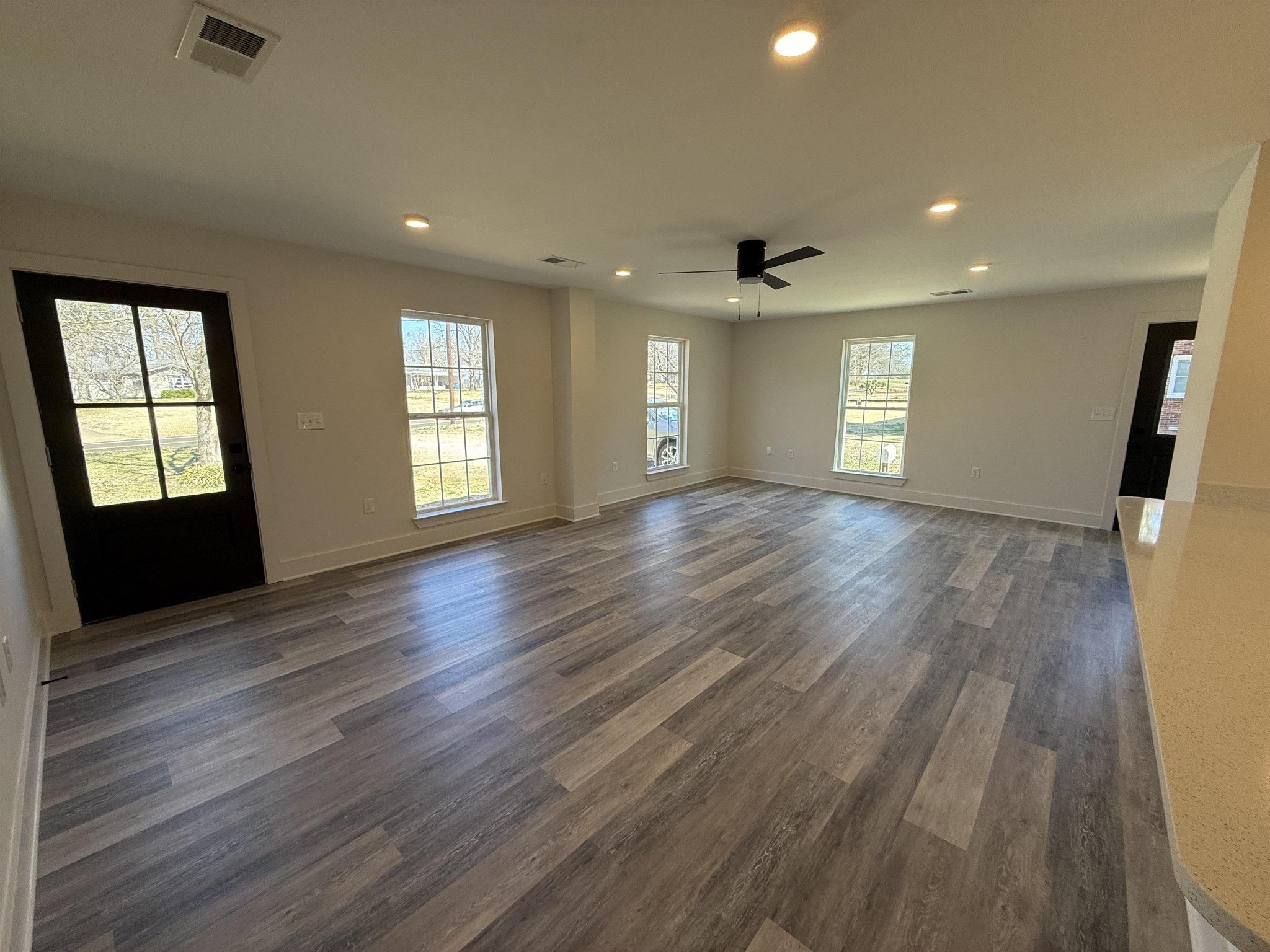 963 Highway 54 Covington, TN 38019 - Photo 16 of 26 an empty room with wooden floor and windows