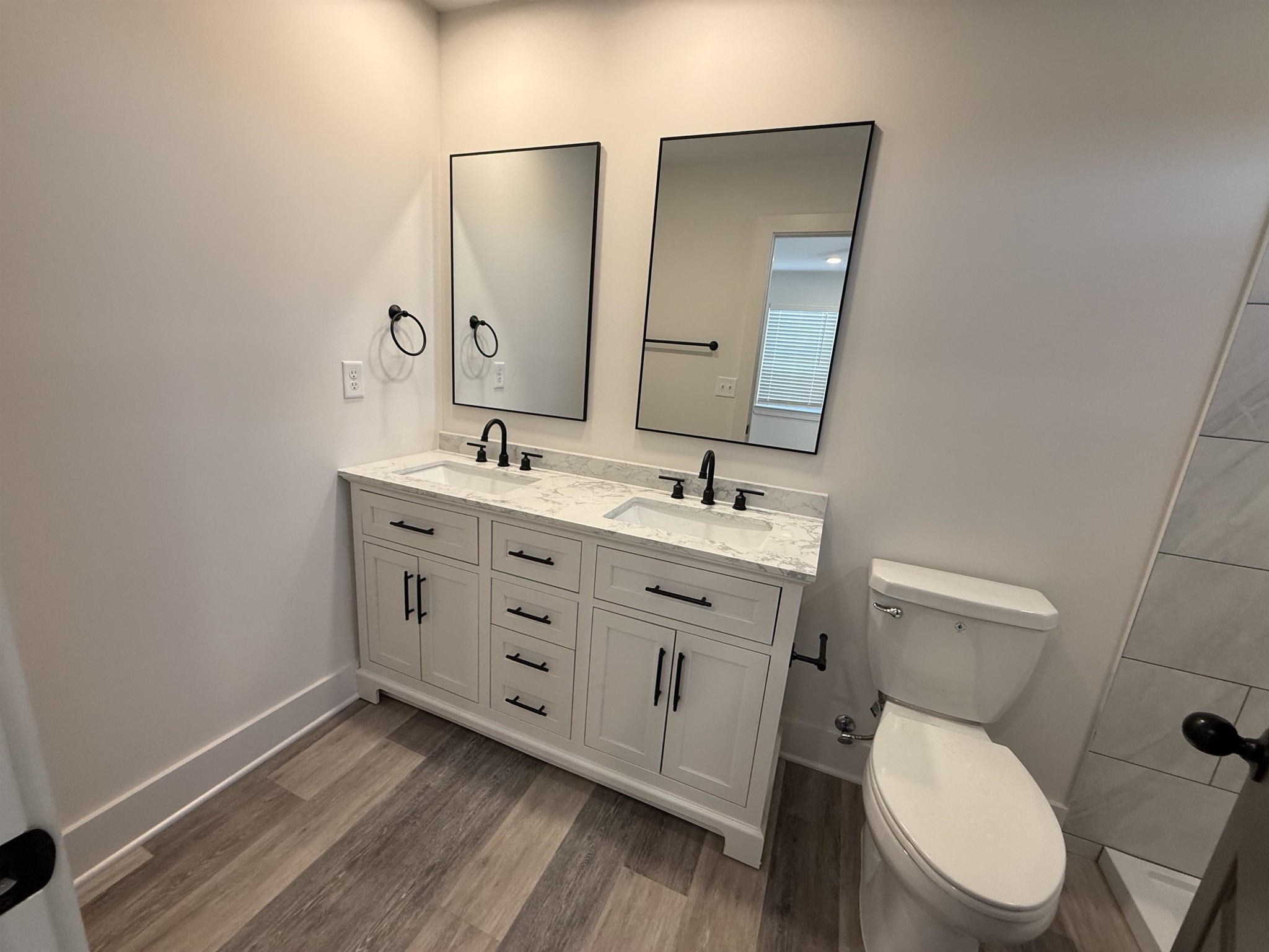 963 Highway 54 Covington, TN 38019 - Photo 18 of 26 a bathroom with a toilet a sink a mirror and vanity