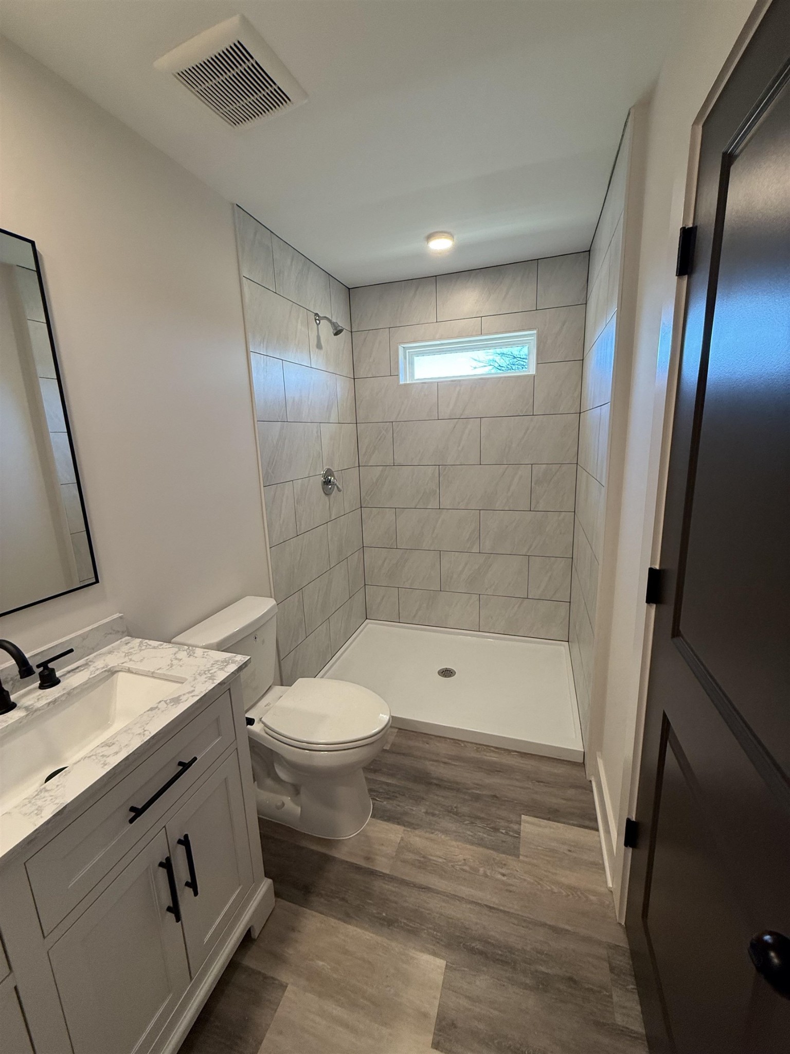 963 Highway 54 Covington, TN 38019 - Photo 19 of 26 a bathroom with a sink a toilet and shower