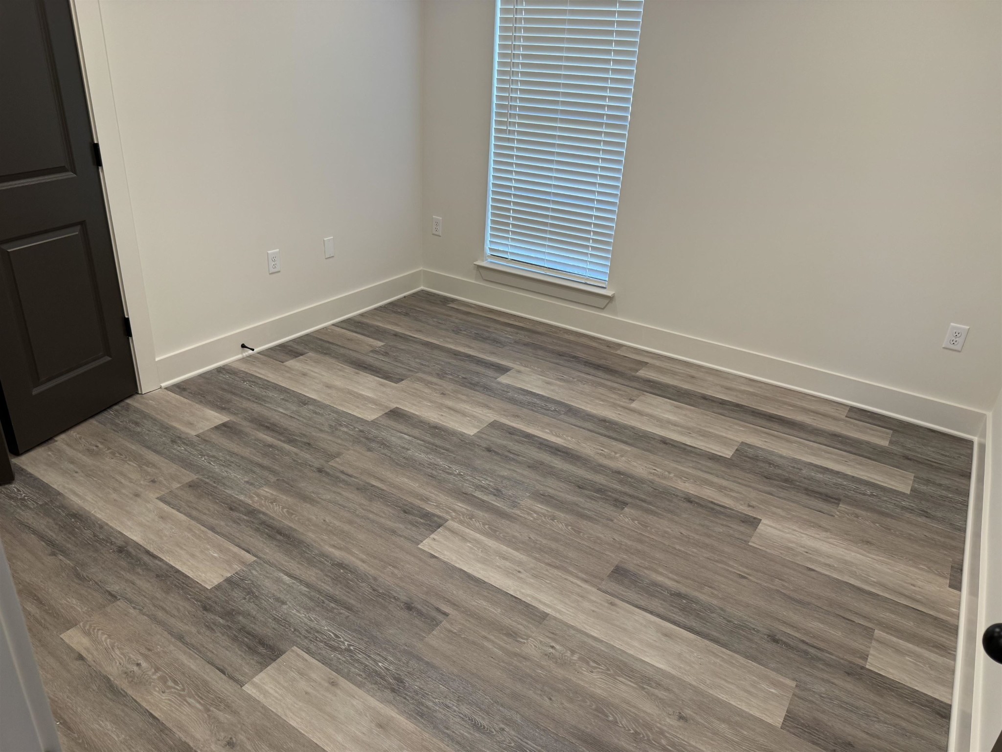 963 Highway 54 Covington, TN 38019 - Photo 22 of 26 a view of a room that has a window and wooden floor