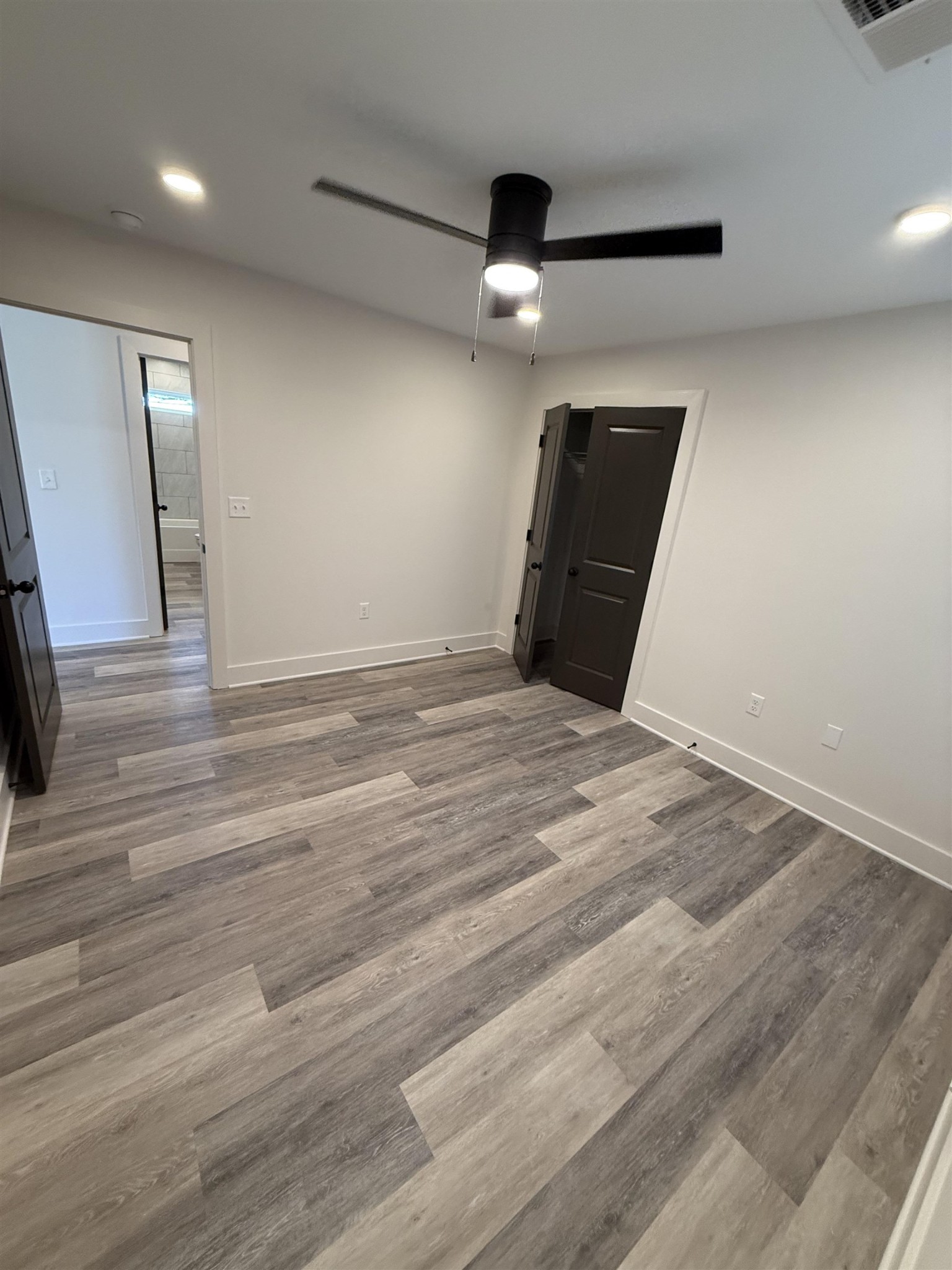963 Highway 54 Covington, TN 38019 - Photo 24 of 26 an empty room with wooden floor and windows
