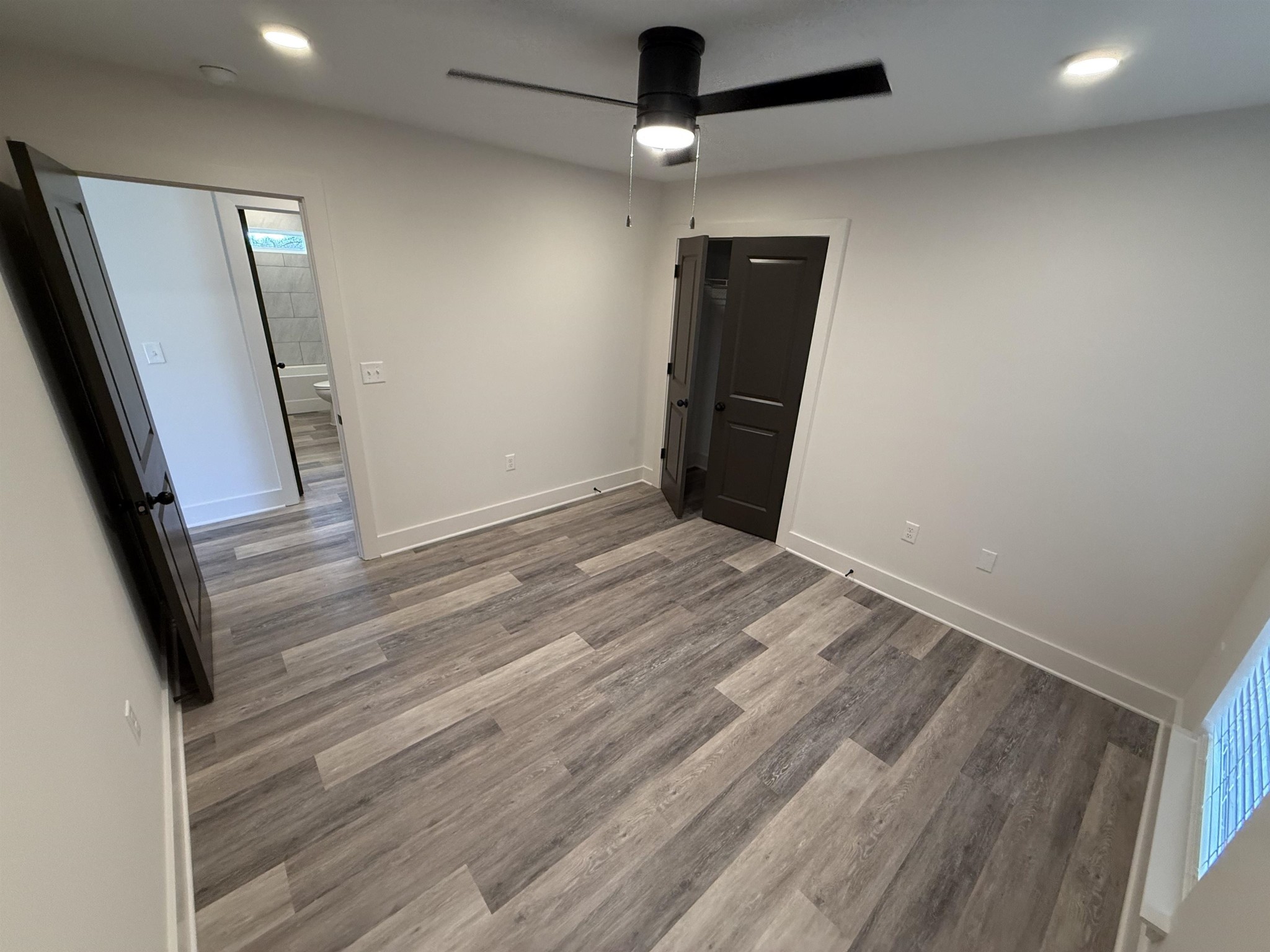 963 Highway 54 Covington, TN 38019 - Photo 25 of 26 an empty room with wooden floor and windows