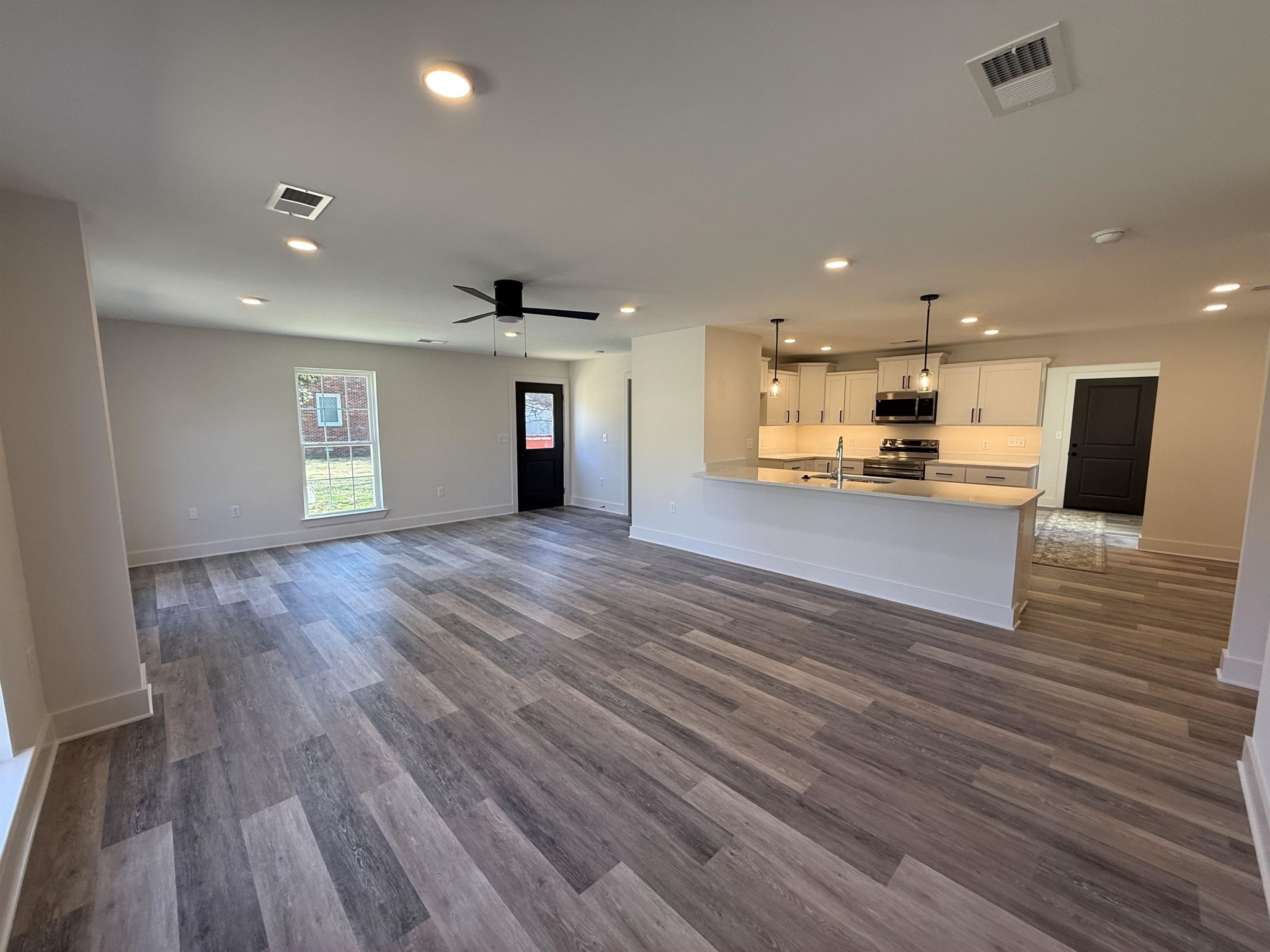 963 Highway 54 Covington, TN 38019 - Photo 7 of 26 a view of a kitchen with a sink and a stove top oven