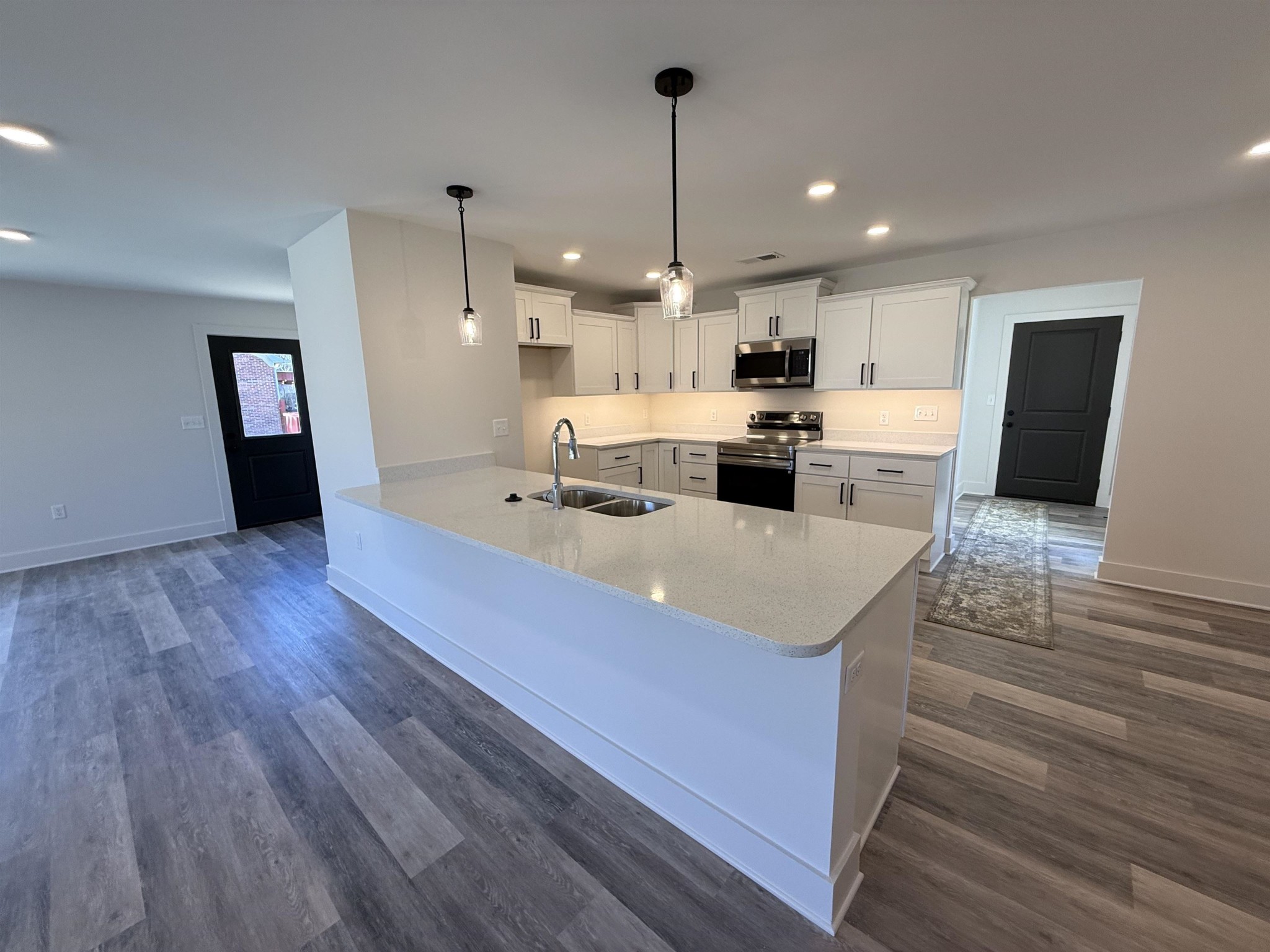 963 Highway 54 Covington, TN 38019 - Photo 9 of 26 a view of a kitchen with kitchen island a sink stainless steel appliances and cabinets