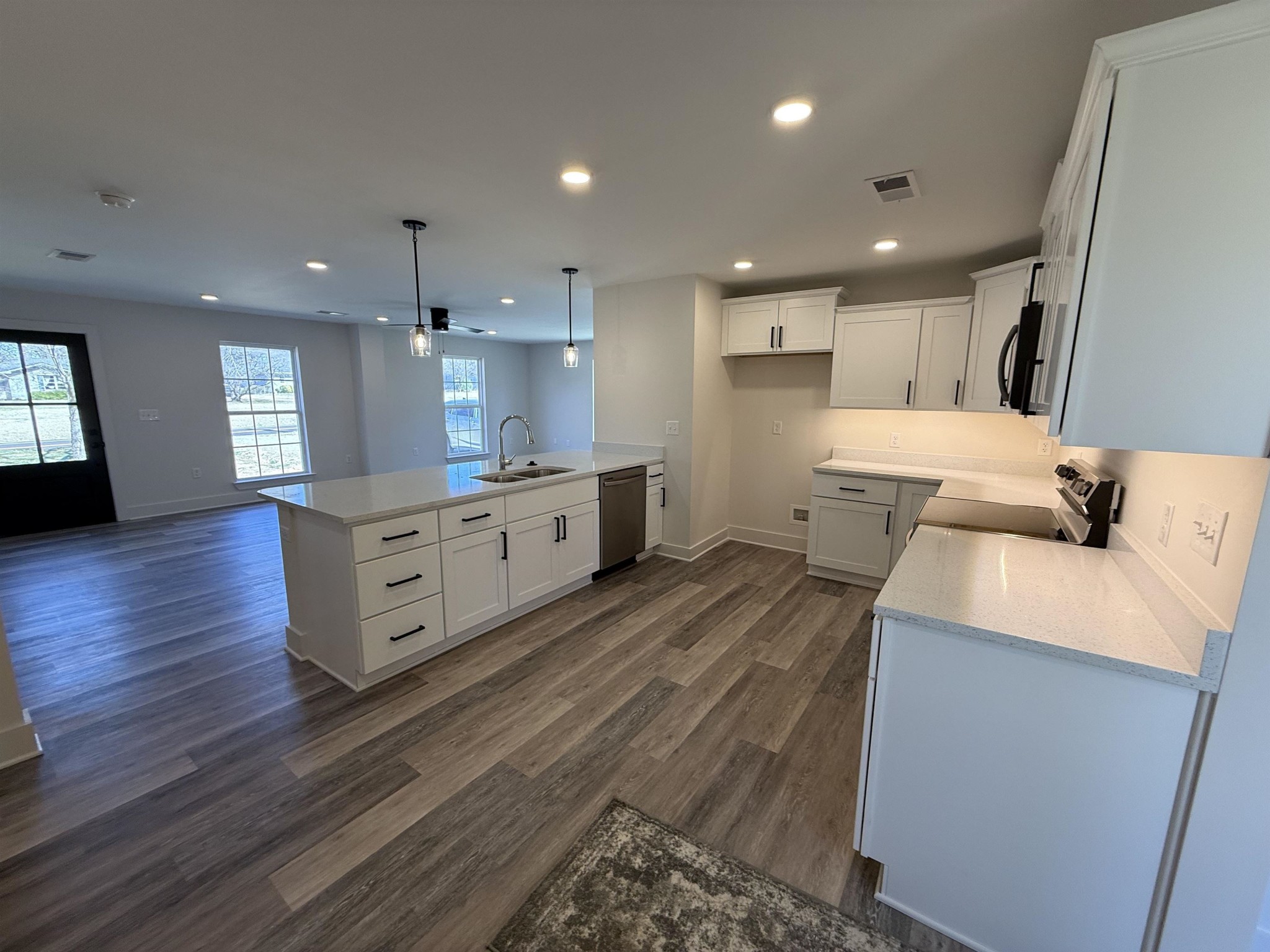 963 Highway 54 Covington, TN 38019 - Photo 10 of 26 a large kitchen with stainless steel appliances kitchen island granite countertop a large counter top a sink and a stove