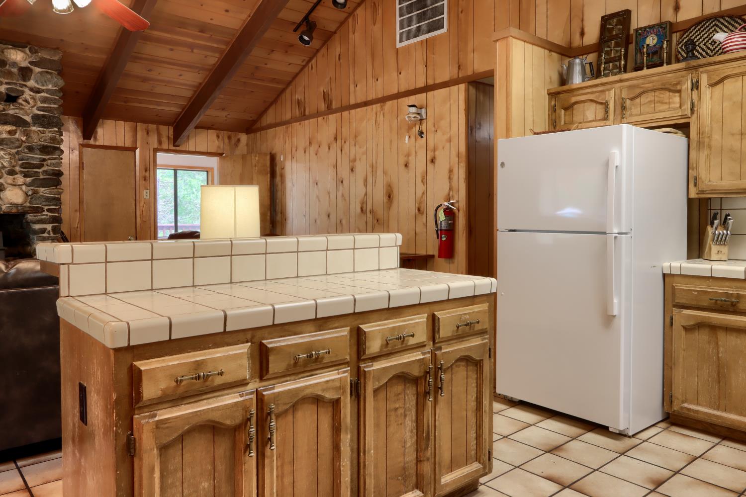 8041 Chilnualna Falls Road Wawona, CA 95389 - Photo 12 of 46 a white refrigerator freezer sitting inside of a kitchen