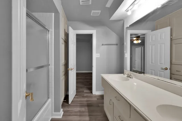a bathroom with a double vanity sink and mirror