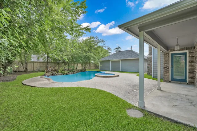 a view of a house with a yard and porch