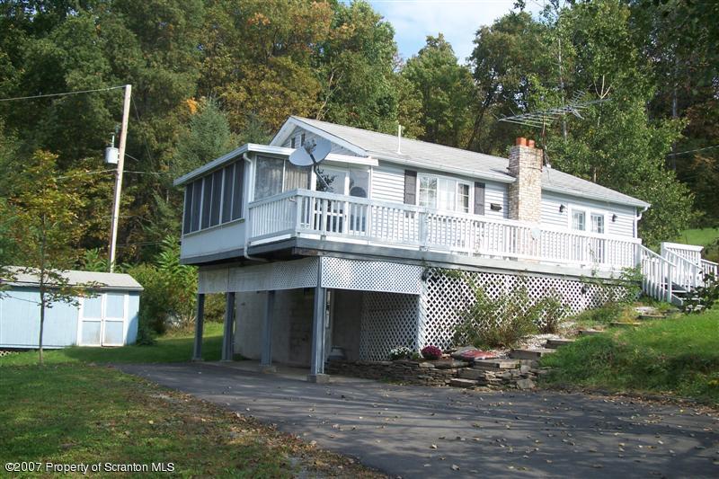 7432 Turnpike Road Montrose, PA 18801 - Photo 1 of 13 a front view of a house with a yard and garage
