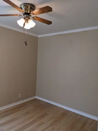 a view of a room with wooden floor