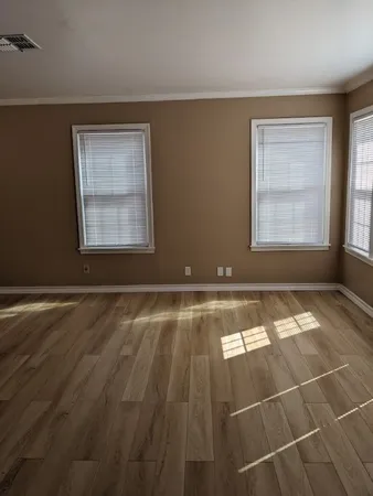 a view of a room with a chandeliers fan