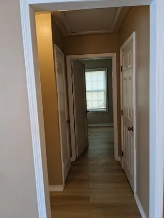 a view of hallway with wooden floor