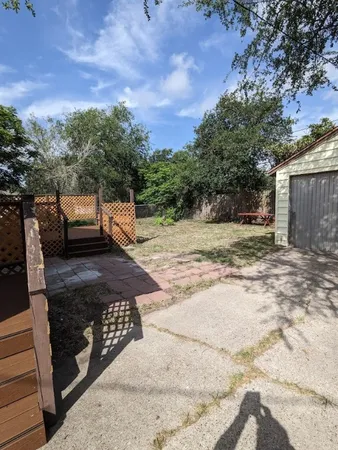 a view of a yard with car parked