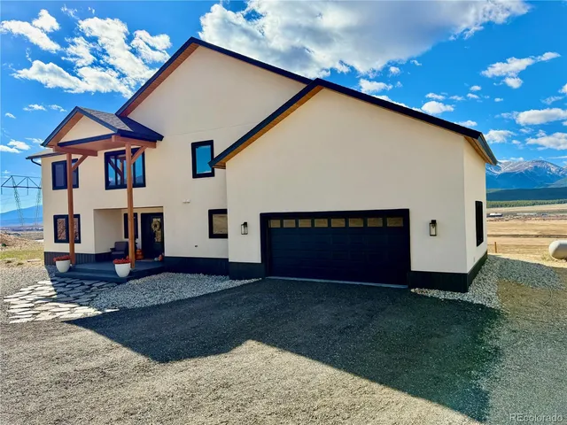 a house with green field in front of it