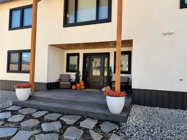 a living room with furniture a fireplace and a flat tv screen