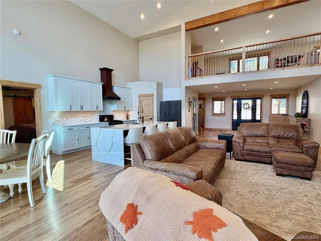 a living room with furniture wooden floor and a flat screen tv