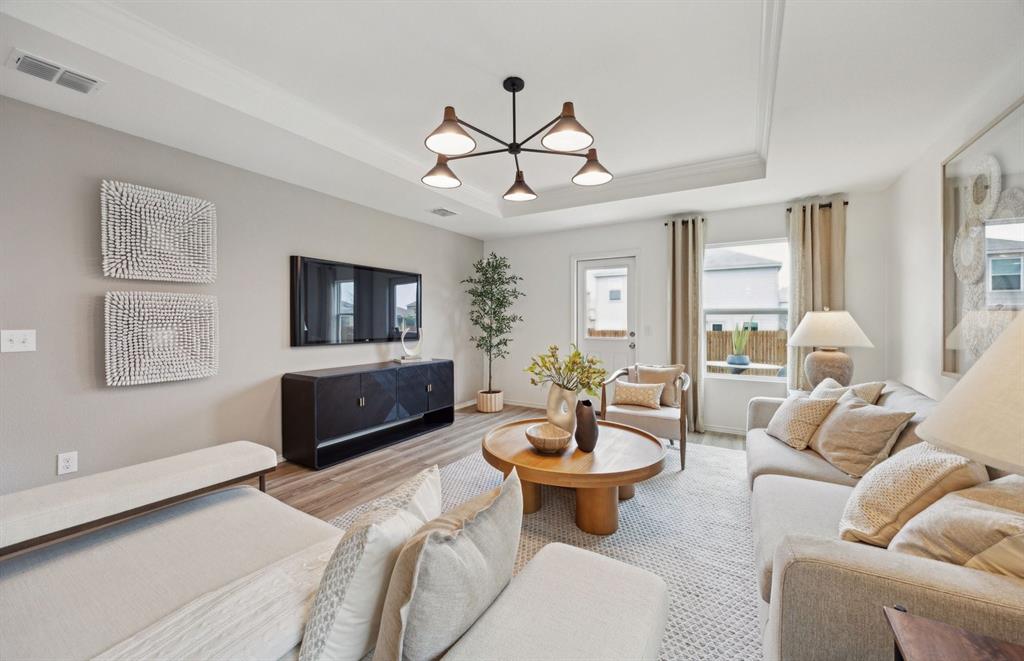 14069 Ladbroke Street Pilot Point, TX 76258 - Photo 5 of 12 a living room with furniture a flat screen tv and a window