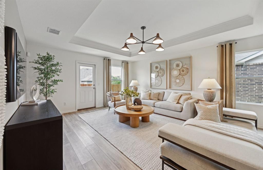 14069 Ladbroke Street Pilot Point, TX 76258 - Photo 6 of 12 a living room with furniture and a chandelier