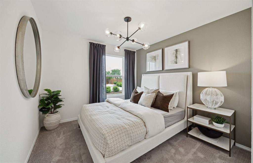 14069 Ladbroke Street Pilot Point, TX 76258 - Photo 10 of 12 a bedroom with bed and a chandelier