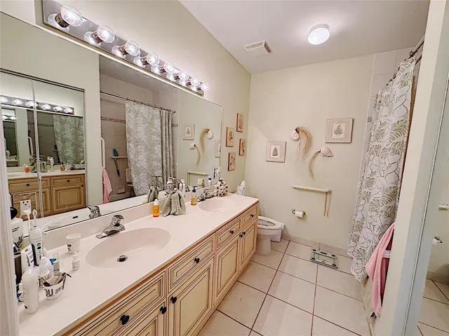 a spacious bathroom with a double vanity sink mirror double and shower