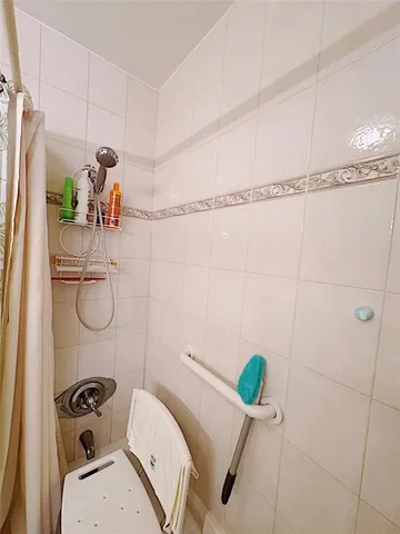 a bathroom with a sink mirror and shower