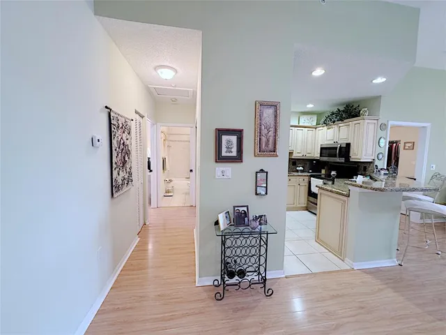 a living room with furniture and kitchen view