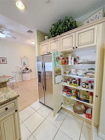 a kitchen with stainless steel appliances a refrigerator and cabinets