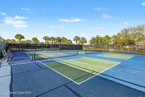 a view of tennis court with houses
