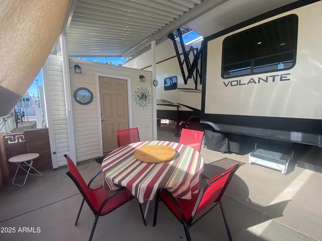 a outdoor dining space with furniture and wooden floor