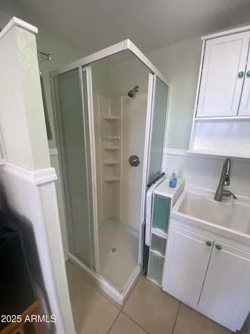 a kitchen with white cabinets and appliances