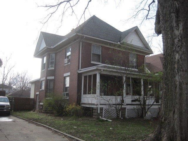 105 6th Avenue Sterling, IL 61081 - Photo 2 of 2 a view of a white house with a yard and plants