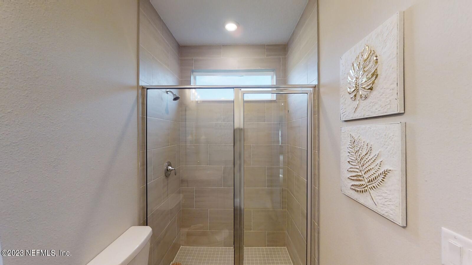 210 White Rabbit Run St. Augustine, FL 32092 - Photo 9 of 18 a bathroom with a shower and a sink