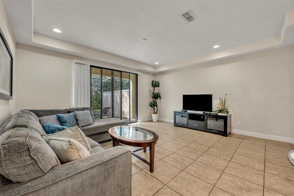 8177 Roseville Road Davenport, FL 33896 - Photo 11 of 39 a living room with furniture and a flat screen tv