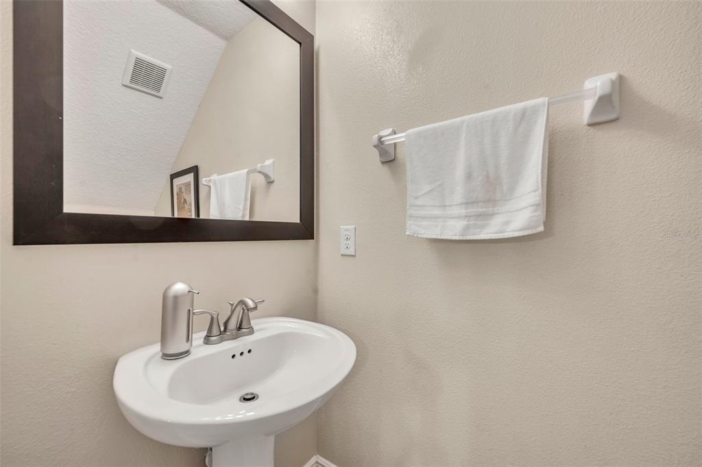 8177 Roseville Road Davenport, FL 33896 - Photo 16 of 39 a bathroom with a sink and a mirror