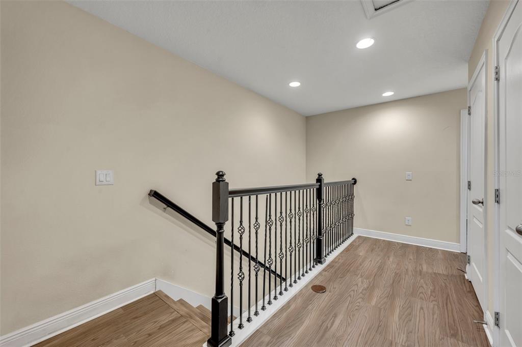 8177 Roseville Road Davenport, FL 33896 - Photo 22 of 39 a view of a hallway with wooden floor and staircase