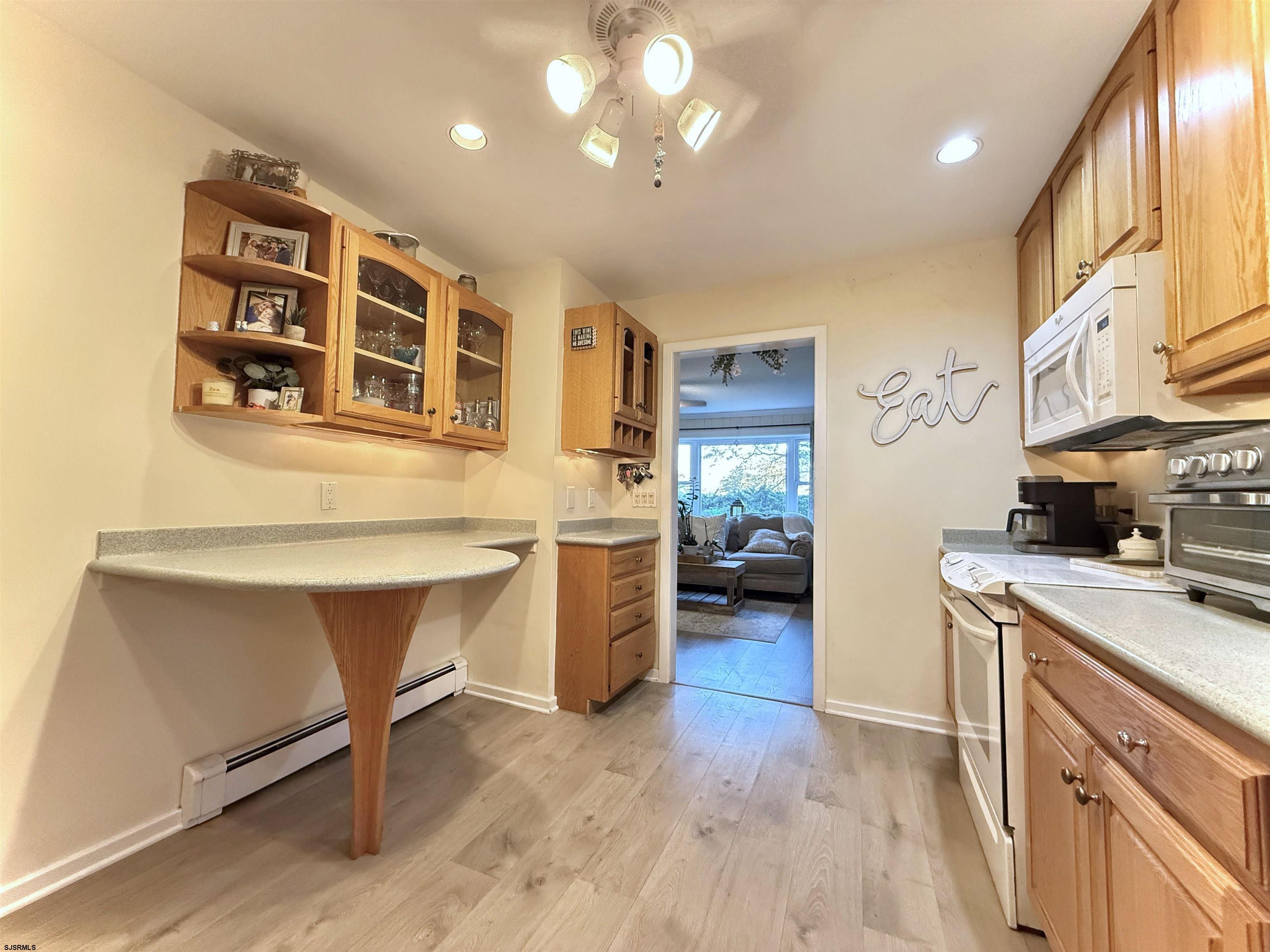 605 Shore Road Linwood, NJ 08221 - Photo 23 of 99 a kitchen with stainless steel appliances granite countertop a stove a sink dishwasher and a refrigerator with wooden floor