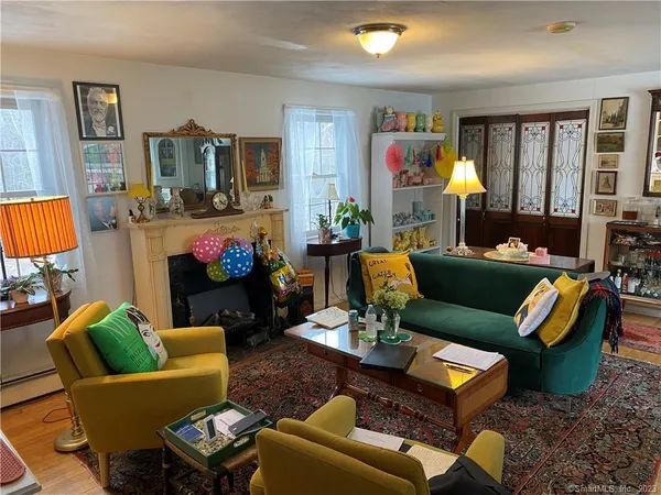 a living room with fireplace furniture and a flat screen tv