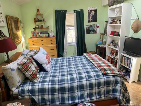 a bedroom with a bed and flat screen tv