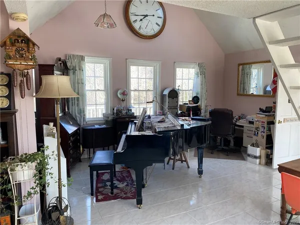 a view of a dining room with furniture and a chandelier