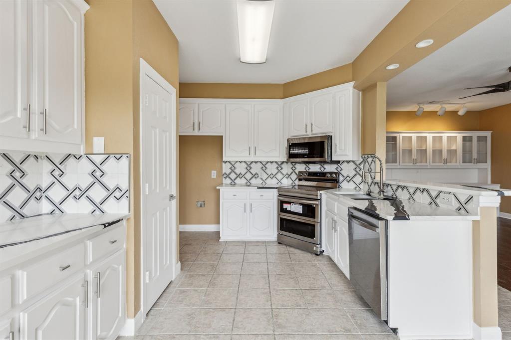 9434 Abbey Road Irving, TX 75063 - Photo 8 of 26 Kitchen has renovated countertops and backsplash