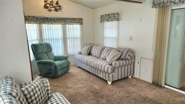 a living room with furniture and a curtain