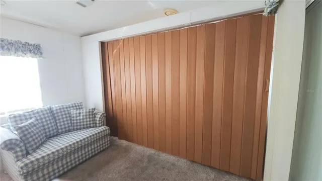 a view of a hallway with wooden cabinets