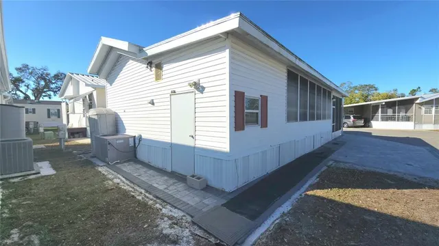 a view of house with backyard outdoor seating and entertaining space