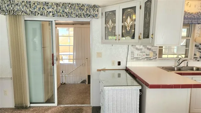 a kitchen with stainless steel appliances a sink a stove a refrigerator and cabinets